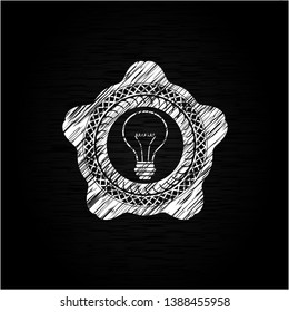 idea icon inside chalkboard emblem