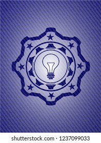 idea icon inside emblem with denim high quality background