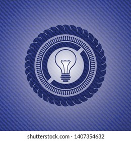 idea icon inside emblem with denim texture