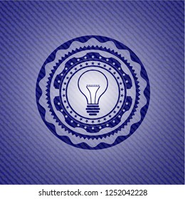 idea icon inside emblem with jean background