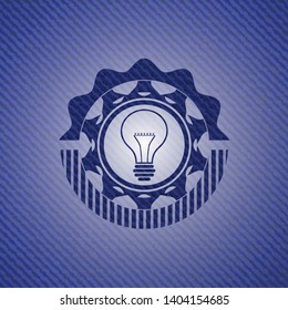 idea icon inside emblem with jean background