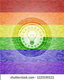 idea icon inside emblem on mosaic background with the colors of the LGBT flag
