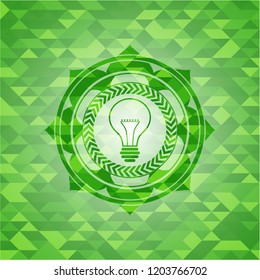 idea icon inside green emblem with mosaic background