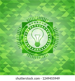 idea icon inside green emblem with mosaic background