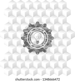 idea icon inside grey badge with geometric cube white background