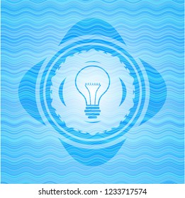idea icon inside light blue water wave badge.