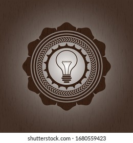 idea icon inside wooden emblem