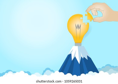 Idea of success.Closeup hand of businessman connecting jigsaw puzzle of light bulb with copy space.Light bulb on the mountain.Creativity.Success and strategy concept.Vector Illustration.