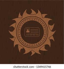 identification card icon inside badge with wooden background