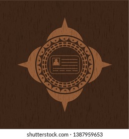 identification card icon inside badge with wooden background