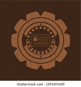 identification card icon inside badge with wood background