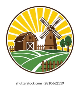 Idyllic countryside landscape with brown windmill and barn on green field at sunrise or sunset