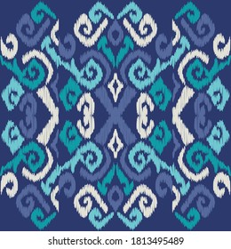 Ikat. Abstract ethnic pattern on fabric in Indonesia and other Asian countries. Seamless background. Vector illustration for web design or print.