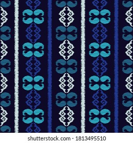 Ikat. Abstract ethnic pattern on fabric in Indonesia and other Asian countries. Seamless background. Vector illustration for web design or print.
