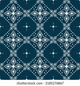 Vector de fondo étnico Ikat. Patrón tribal sin fisuras de diamantes de formas geométricas blancas sobre fondo azul oscuro en el concepto de flor y estrella. Diseño de alfombra, papel pintado, fondo, envoltura, tela.