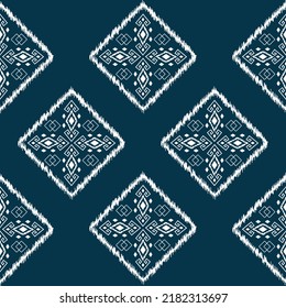 Ikat ethnic background vector. seamless square pattern of white traditional geometric shapes on dark blue background.