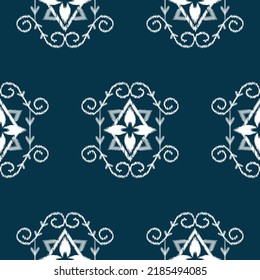 Ikat ethnic background vector. Seamless tribal pattern of white geometric shapes on dark blue background in flower and ivy concept. Design for carpet, wallpaper, background, wrapping,clothing, fabric.
