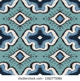 Ikat geometric folklore ornament with diamonds. Damask rug. Tribal ethnic vector texture. Persian geo print. Seamless pattern in Aztec style. Folk embroidery. Gypsy, Mexican, African print. 