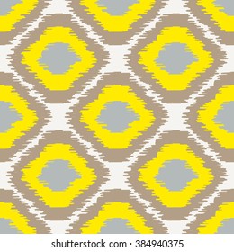 Ikat geometric seamless pattern. Yellow and brown color collection. Indonesian textile fabric tie-dye technique inspiration. Rhombus and drop shapes.