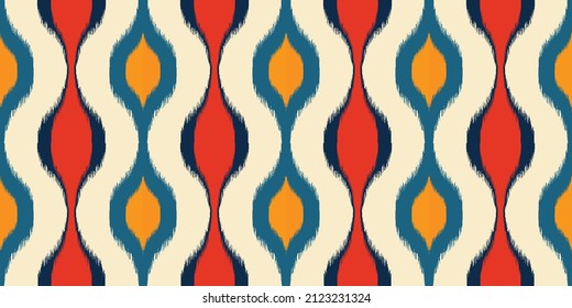 Ikat ogee vector seamless pattern. Abstract baroque flower background for fabric, print or wrapping paper. Red blue Yellow and White design. Using in fashion industry