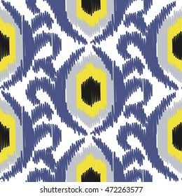 Ikat ogee vector seamless pattern. Abstract floral background for fabric, print or wrapping paper. Indigo blue and yellow design.