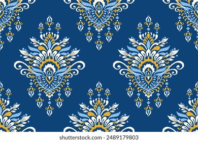 Ikat paisley design seamless pattern on blue background vector illustration.Ikat ethnic oriental embroidery traditional.Aztec style,abstract background.design for texture,fabric,clothing,decoration,scarf.