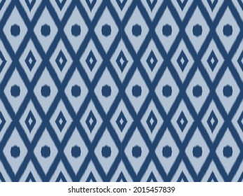 Ikat pattern as ethnic fabric in blue tone with switching circle and diamond design. Wallpaper seamless pattern design in navy blue color. Design for fabric, wallpaper, background in pastel tone. 