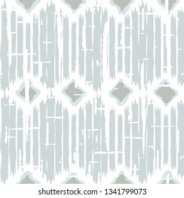 Ikat pattern vector. Geometric background with ethnic rug fabric texture and chevron shapes in neutral pastel colors.