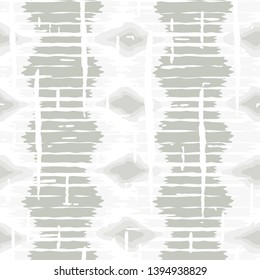 Ikat pattern vector. Geometric background with ethnic rug fabric texture and chevron shapes in neutral pastel colors.