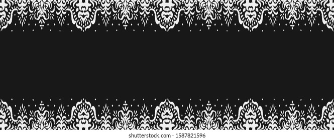 Ikat seamless pattern. Border with snowflakes. Openwork lace. New year Christmas background. Vector tie dye shibori print with stripes and chevron. Ink textured japanese background. Bohemian fashion. 