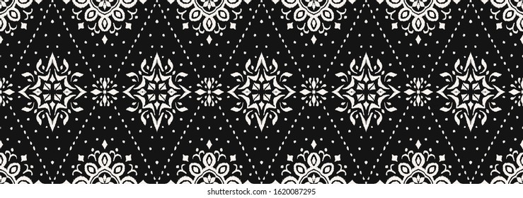 Ikat seamless pattern. Border with snowflakes. Openwork lace. New year Christmas background. Vector tie dye shibori print with stripes and chevron. Ink textured japanese background. Bohemian fashion. 