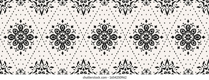 Ikat seamless pattern. Border with snowflakes. Openwork lace. New year Christmas background. Vector tie dye shibori print with stripes and chevron. Ink textured japanese background. Bohemian fashion. 