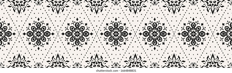 Ikat seamless pattern. Border with snowflakes. Openwork lace. New year Christmas background. Vector tie dye shibori print with stripes and chevron. Ink textured japanese background. Bohemian fashion. 