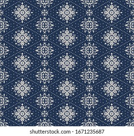 Ikat seamless pattern. Border with snowflakes. Openwork lace. New year Christmas background. Vector tie dye shibori print with stripes and chevron. Ink textured japanese background. Bohemian fashion. 