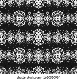 Ikat seamless pattern. Border with snowflakes. Openwork lace. New year Christmas background. Vector tie dye shibori print with stripes and chevron. Ink textured japanese background. Bohemian fashion. 