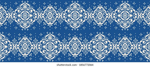 Ikat seamless pattern. Border with snowflakes. Openwork lace. New year Christmas background. Vector tie dye shibori print with stripes and chevron. Ink textured japanese background. Bohemian fashion. 