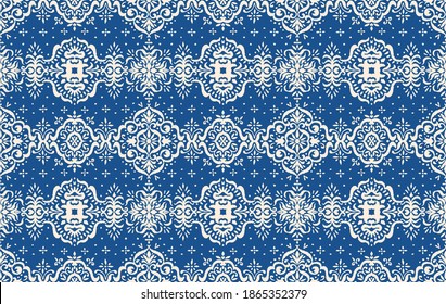 Ikat seamless pattern. Border with snowflakes. Openwork lace. New year Christmas background. Vector tie dye shibori print with stripes and chevron. Ink textured japanese background. Bohemian fashion. 