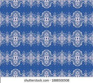 Ikat seamless pattern. Border with snowflakes. Openwork lace. New year Christmas background. Vector tie dye shibori print with stripes and chevron. Ink textured japanese background. Bohemian fashion. 