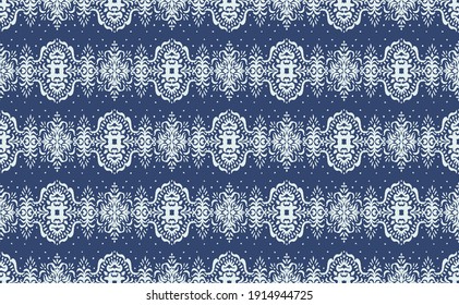Ikat seamless pattern. Border with snowflakes. Openwork lace. New year Christmas background. Vector tie dye shibori print with stripes and chevron. Ink textured japanese background. Bohemian fashion. 