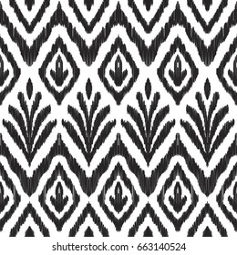 Ikat seamless pattern. Fancy textile design. Vector illustration in white and black colors. Tapestry print in ethnic style. 