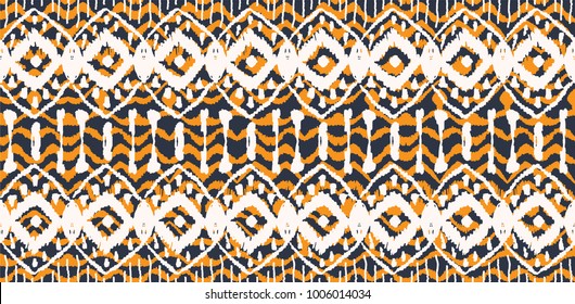 Ikat seamless pattern. Vector tie dye  shibori print with stripes and chevron. Ink textured japanese background.  Ethnic fabric vector. Bohemian fashion. Endless watercolor texture. African rug.