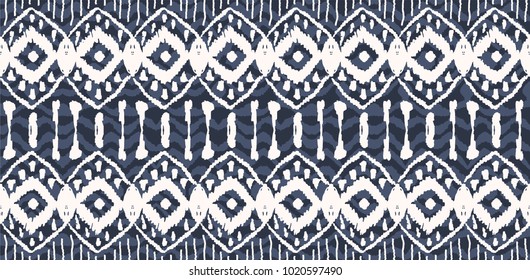 Ikat seamless pattern. Vector tie dye  shibori print with stripes and chevron. Ink textured japanese background.  Ethnic fabric vector. Bohemian fashion. Endless watercolor texture. African rug.