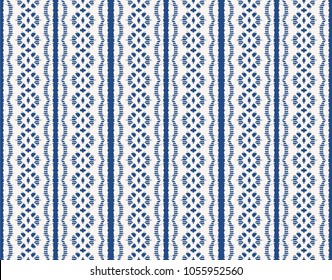 Ikat seamless pattern. Vector tie dye shibori print with stripes and chevron. 