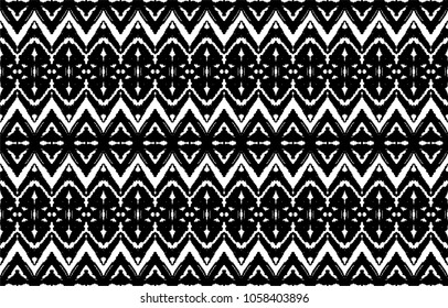 Ikat seamless pattern. Vector tie dye shibori print with stripes and chevron. Ink textured japanese background. Ethnic fabric vector. Bohemian fashion. Endless watercolor texture. African rug.