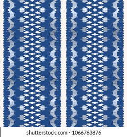 Ikat seamless pattern. Vector tie dye shibori print with stripes and chevron. Ink textured japanese background. Ethnic fabric vector. Bohemian fashion. Endless watercolor texture. African rug.