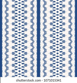 Ikat seamless pattern. Vector tie dye shibori print with stripes and chevron. Ink textured japanese background. Ethnic fabric vector. Bohemian fashion. Endless watercolor texture. African rug.