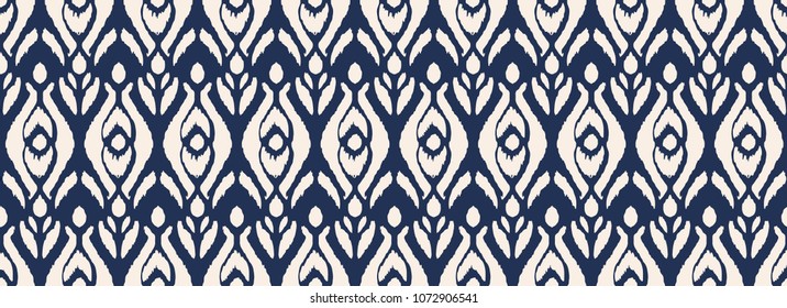 Ikat seamless pattern. Vector tie dye shibori print with stripes and chevron. Ink textured japanese background. Ethnic fabric vector. Bohemian fashion. Endless watercolor texture. African rug.
