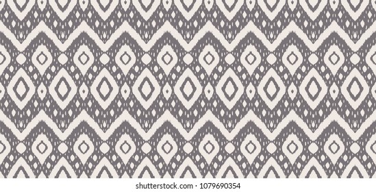 Ikat seamless pattern. Vector tie dye shibori print with stripes and chevron. Ink textured japanese background. Ethnic fabric vector. Bohemian fashion. Endless watercolor texture. African rug.