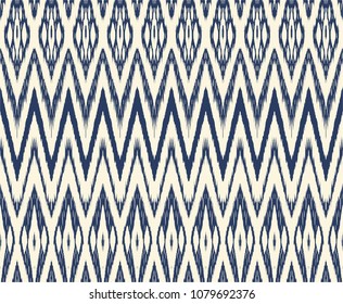 Ikat seamless pattern. Vector tie dye shibori print with stripes and chevron. Ink textured japanese background. Ethnic fabric vector. Bohemian fashion. Endless watercolor texture. African rug.