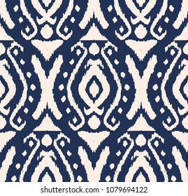 Ikat seamless pattern. Vector tie dye shibori print with stripes and chevron. Ink textured japanese background. Ethnic fabric vector. Bohemian fashion. Endless watercolor texture. African rug.